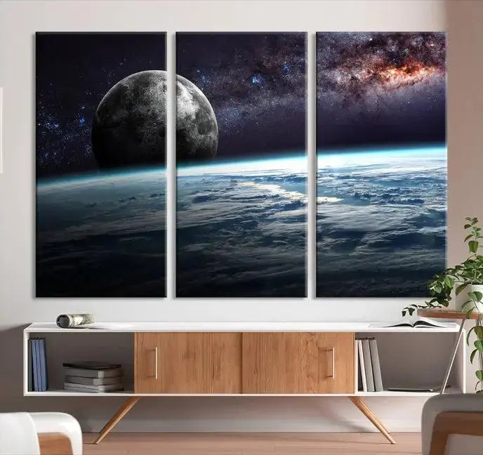 The Space and Planet Canvas Print, a triptych showcasing Earth and the Moon from space on museum-quality canvas with UV-protective coating, hangs prominently in the room.