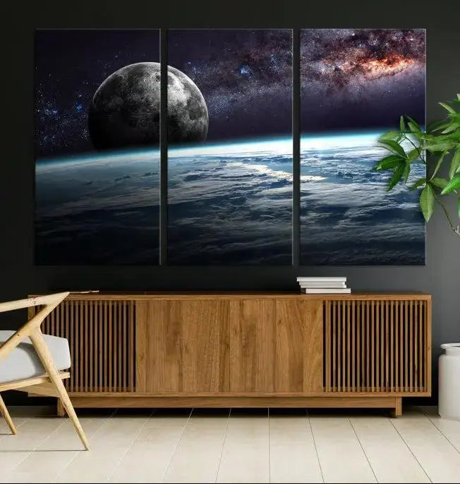 The Space and Planet Canvas Print, a triptych showcasing Earth and the Moon from space on museum-quality canvas with UV-protective coating, hangs prominently in the room.