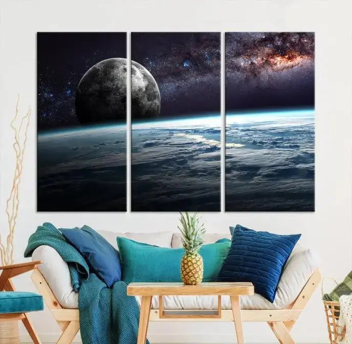 The Space and Planet Canvas Print, a triptych showcasing Earth and the Moon from space on museum-quality canvas with UV-protective coating, hangs prominently in the room.