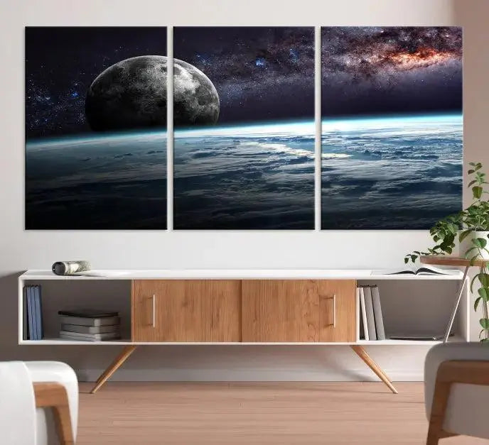 The Space and Planet Canvas Print, a triptych showcasing Earth and the Moon from space on museum-quality canvas with UV-protective coating, hangs prominently in the room.