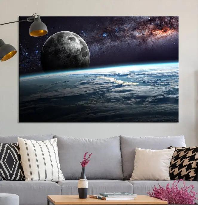 The Space and Planet Canvas Print, a triptych showcasing Earth and the Moon from space on museum-quality canvas with UV-protective coating, hangs prominently in the room.