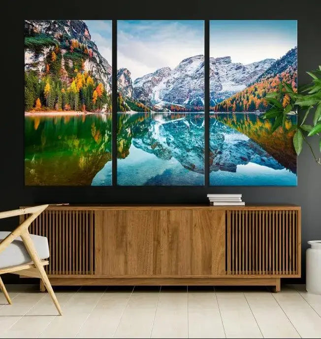 The "Spectacular Autumn View of Braies Lake Wall Art Canvas Print" showcases a serene mountain lake framed by colorful autumn trees reflected in the water. This museum-quality artwork is adorned with a UV-protective coating to maintain its vivid colors and elegantly gallery wrapped to enhance its contemporary appeal.