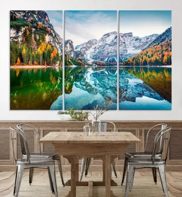 The "Spectacular Autumn View of Braies Lake Wall Art Canvas Print" showcases a serene mountain lake framed by colorful autumn trees reflected in the water. This museum-quality artwork is adorned with a UV-protective coating to maintain its vivid colors and elegantly gallery wrapped to enhance its contemporary appeal.