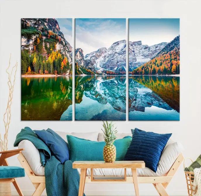 The "Spectacular Autumn View of Braies Lake Wall Art Canvas Print" showcases a serene mountain lake framed by colorful autumn trees reflected in the water. This museum-quality artwork is adorned with a UV-protective coating to maintain its vivid colors and elegantly gallery wrapped to enhance its contemporary appeal.