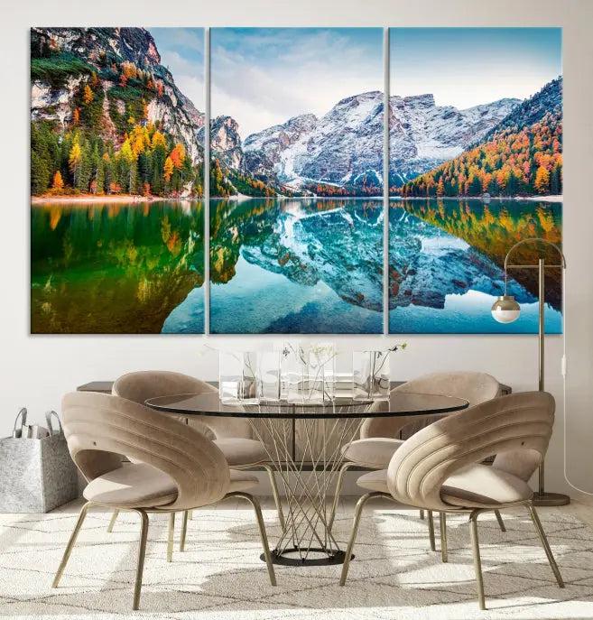 The "Spectacular Autumn View of Braies Lake Wall Art Canvas Print" showcases a serene mountain lake framed by colorful autumn trees reflected in the water. This museum-quality artwork is adorned with a UV-protective coating to maintain its vivid colors and elegantly gallery wrapped to enhance its contemporary appeal.