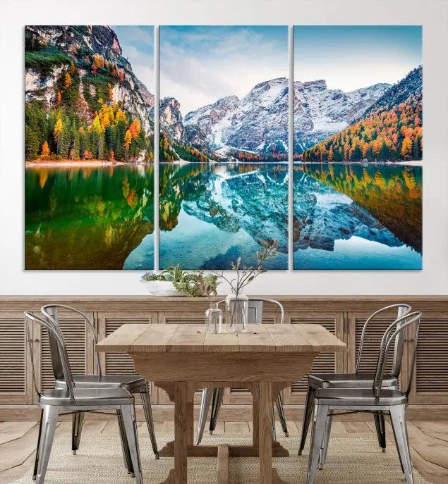 The "Spectacular Autumn View of Braies Lake Wall Art Canvas Print" showcases a serene mountain lake framed by colorful autumn trees reflected in the water. This museum-quality artwork is adorned with a UV-protective coating to maintain its vivid colors and elegantly gallery wrapped to enhance its contemporary appeal.