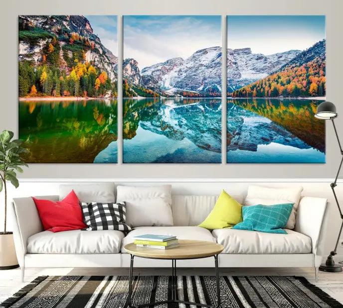 The "Spectacular Autumn View of Braies Lake Wall Art Canvas Print" showcases a serene mountain lake framed by colorful autumn trees reflected in the water. This museum-quality artwork is adorned with a UV-protective coating to maintain its vivid colors and elegantly gallery wrapped to enhance its contemporary appeal.