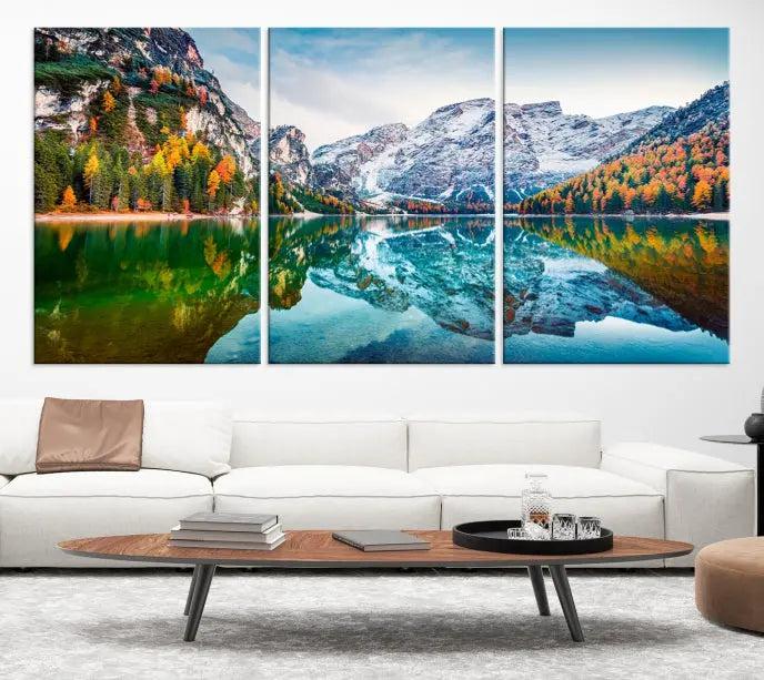 The "Spectacular Autumn View of Braies Lake Wall Art Canvas Print" showcases a serene mountain lake framed by colorful autumn trees reflected in the water. This museum-quality artwork is adorned with a UV-protective coating to maintain its vivid colors and elegantly gallery wrapped to enhance its contemporary appeal.