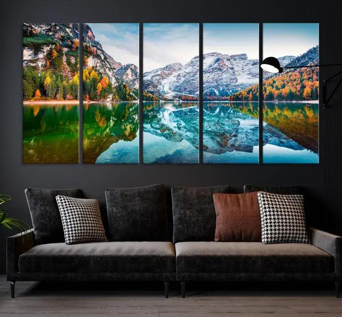 The "Spectacular Autumn View of Braies Lake Wall Art Canvas Print" showcases a serene mountain lake framed by colorful autumn trees reflected in the water. This museum-quality artwork is adorned with a UV-protective coating to maintain its vivid colors and elegantly gallery wrapped to enhance its contemporary appeal.