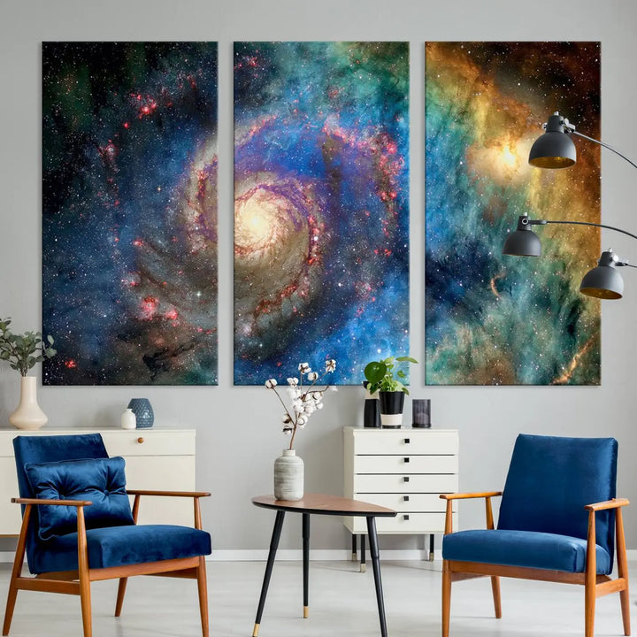 The living room showcases three colorful space-themed paintings titled "Spiral Galaxy Wall Art Canvas Print" on the wall, featuring museum-quality craftsmanship with vibrant colors through high-resolution printing.