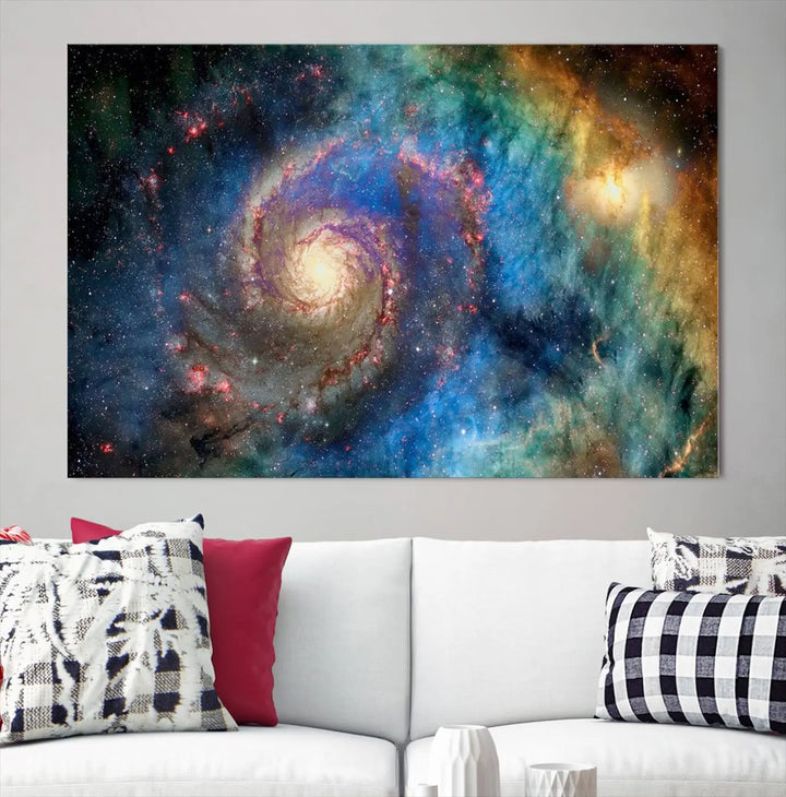 The living room showcases three colorful space-themed paintings titled "Spiral Galaxy Wall Art Canvas Print" on the wall, featuring museum-quality craftsmanship with vibrant colors through high-resolution printing.