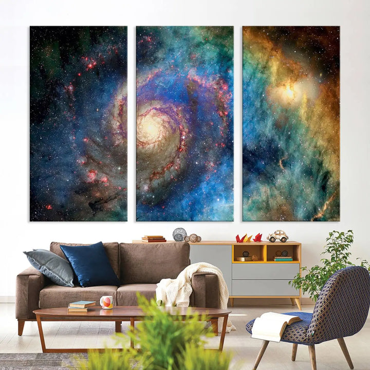 The living room showcases three colorful space-themed paintings titled "Spiral Galaxy Wall Art Canvas Print" on the wall, featuring museum-quality craftsmanship with vibrant colors through high-resolution printing.