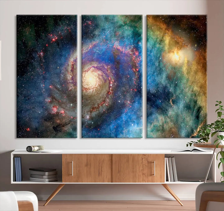 The living room showcases three colorful space-themed paintings titled "Spiral Galaxy Wall Art Canvas Print" on the wall, featuring museum-quality craftsmanship with vibrant colors through high-resolution printing.