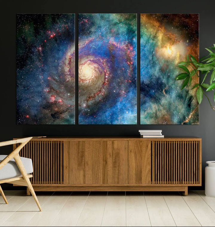 The living room showcases three colorful space-themed paintings titled "Spiral Galaxy Wall Art Canvas Print" on the wall, featuring museum-quality craftsmanship with vibrant colors through high-resolution printing.