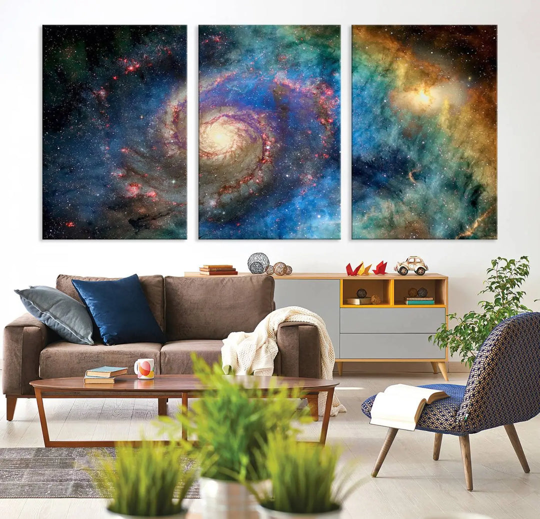 The living room showcases three colorful space-themed paintings titled "Spiral Galaxy Wall Art Canvas Print" on the wall, featuring museum-quality craftsmanship with vibrant colors through high-resolution printing.