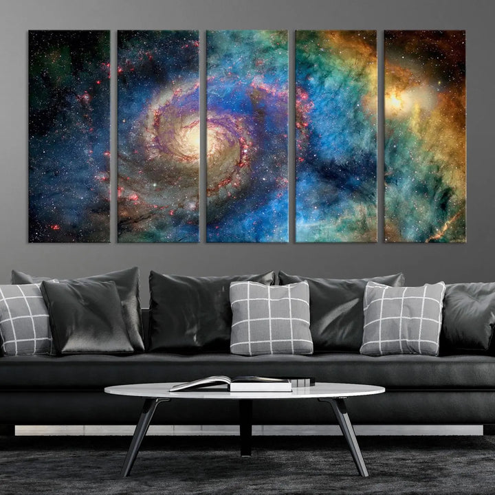 The living room showcases three colorful space-themed paintings titled "Spiral Galaxy Wall Art Canvas Print" on the wall, featuring museum-quality craftsmanship with vibrant colors through high-resolution printing.