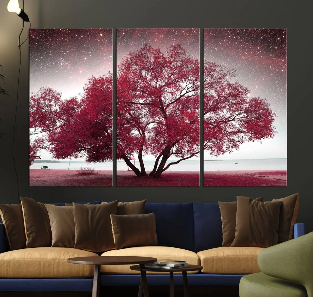 A living room adorned with a museum-quality triptych artwork on gallery-wrapped canvas titled "Spring Night Infrared Red Leaves and Tree," which showcases a pink tree against a starry sky.