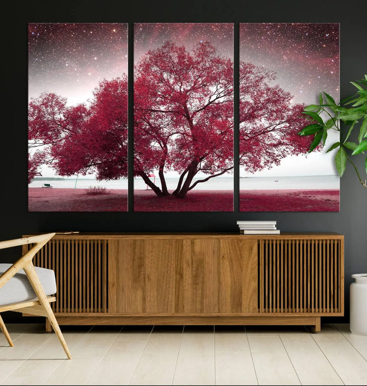 A living room adorned with a museum-quality triptych artwork on gallery-wrapped canvas titled "Spring Night Infrared Red Leaves and Tree," which showcases a pink tree against a starry sky.