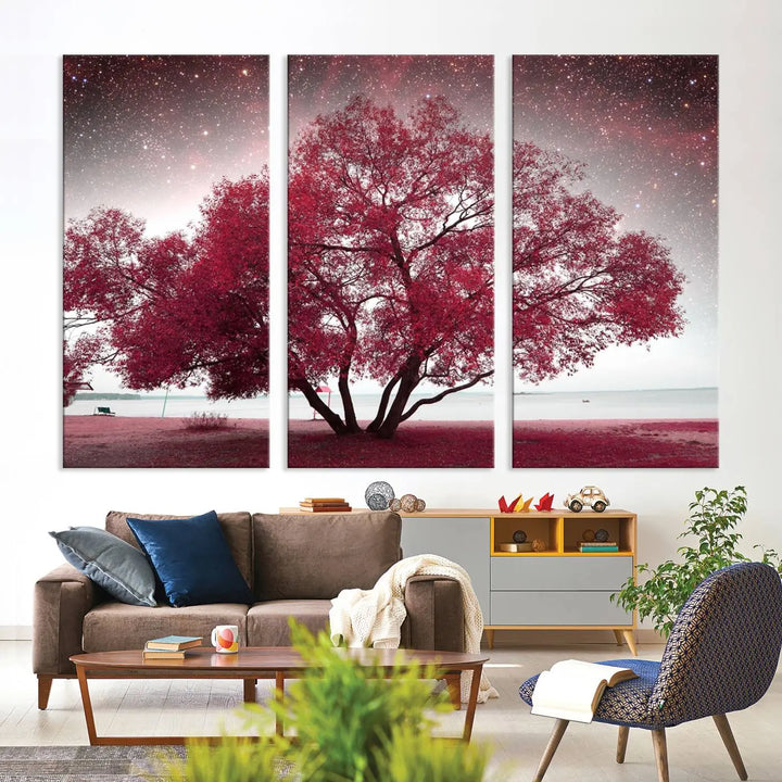 A living room adorned with a museum-quality triptych artwork on gallery-wrapped canvas titled "Spring Night Infrared Red Leaves and Tree," which showcases a pink tree against a starry sky.