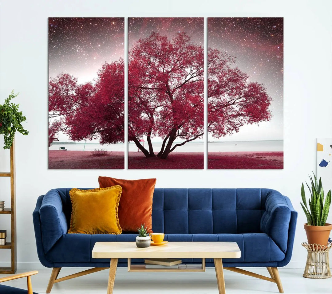 A living room adorned with a museum-quality triptych artwork on gallery-wrapped canvas titled "Spring Night Infrared Red Leaves and Tree," which showcases a pink tree against a starry sky.