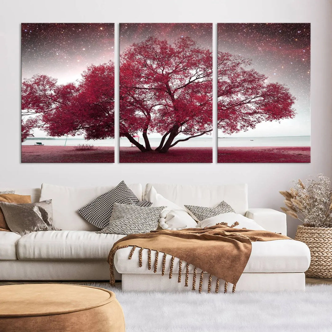 A living room adorned with a museum-quality triptych artwork on gallery-wrapped canvas titled "Spring Night Infrared Red Leaves and Tree," which showcases a pink tree against a starry sky.