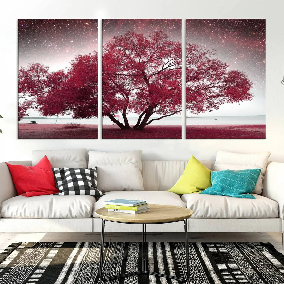 A living room adorned with a museum-quality triptych artwork on gallery-wrapped canvas titled "Spring Night Infrared Red Leaves and Tree," which showcases a pink tree against a starry sky.