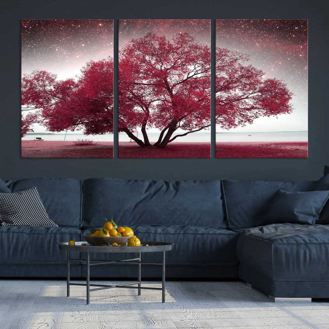 A living room adorned with a museum-quality triptych artwork on gallery-wrapped canvas titled "Spring Night Infrared Red Leaves and Tree," which showcases a pink tree against a starry sky.