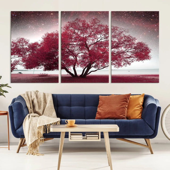 A living room adorned with a museum-quality triptych artwork on gallery-wrapped canvas titled "Spring Night Infrared Red Leaves and Tree," which showcases a pink tree against a starry sky.