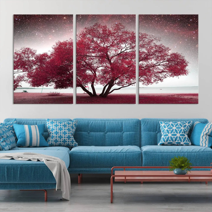 A living room adorned with a museum-quality triptych artwork on gallery-wrapped canvas titled "Spring Night Infrared Red Leaves and Tree," which showcases a pink tree against a starry sky.