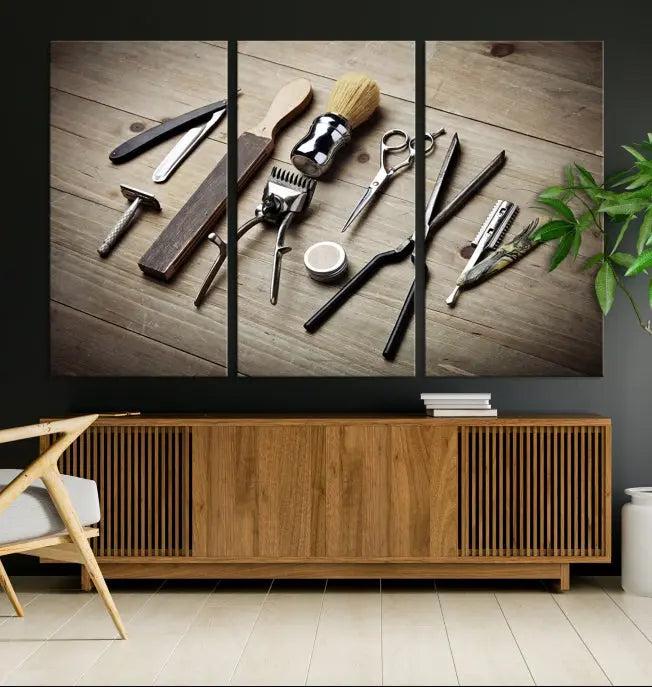 The Standart Barber Tools Wall Art Canvas Print features scissors, clippers, and brushes elegantly arranged on a wooden surface. This piece beautifully captures the essence of barber culture, adding a unique touch to any room.