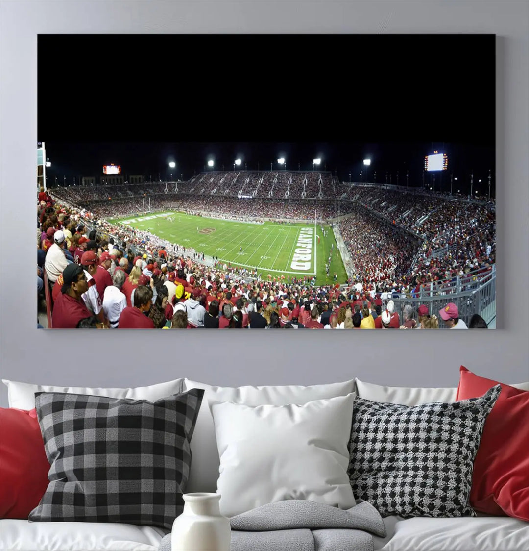 The living room features a large triptych wall art crafted on premium canvas, showcasing the "Stanford University Cardinal Football Team Print - Stanford Stadium," which depicts a crowded football stadium at night. Handmade in the USA.