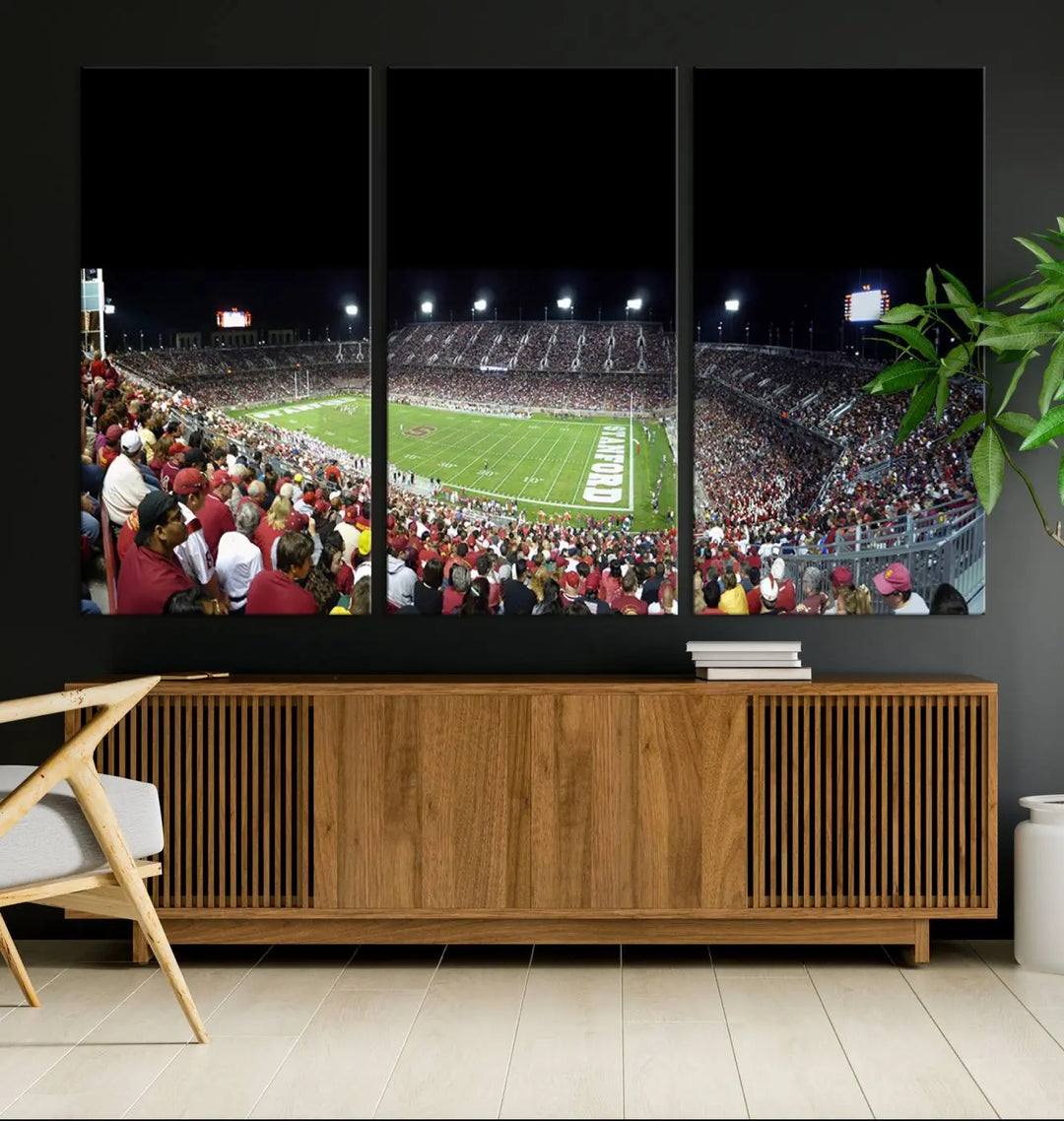 The living room features a large triptych wall art crafted on premium canvas, showcasing the "Stanford University Cardinal Football Team Print - Stanford Stadium," which depicts a crowded football stadium at night. Handmade in the USA.