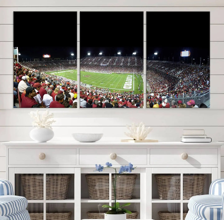 The living room features a large triptych wall art crafted on premium canvas, showcasing the "Stanford University Cardinal Football Team Print - Stanford Stadium," which depicts a crowded football stadium at night. Handmade in the USA.