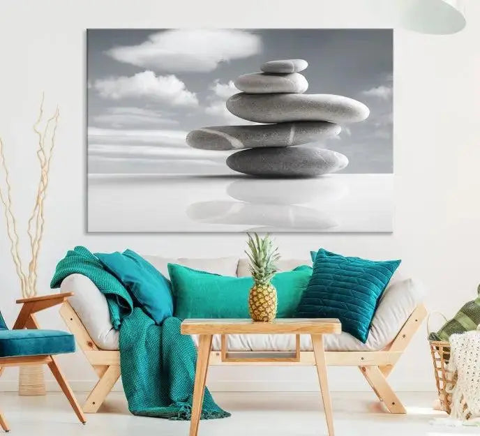 A gallery-quality Still Life Black and White Zen Stones Wall Art Canvas Print, featuring a triptych of stacked stones against a calm, cloudy background, adorns the room to bring an elegant touch.