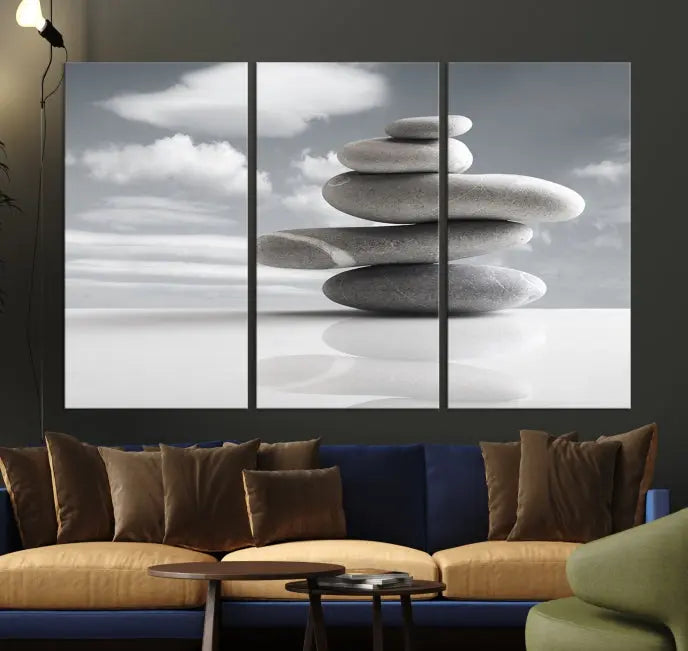 A gallery-quality Still Life Black and White Zen Stones Wall Art Canvas Print, featuring a triptych of stacked stones against a calm, cloudy background, adorns the room to bring an elegant touch.