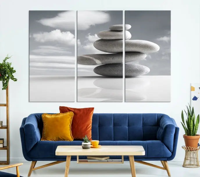 A gallery-quality Still Life Black and White Zen Stones Wall Art Canvas Print, featuring a triptych of stacked stones against a calm, cloudy background, adorns the room to bring an elegant touch.