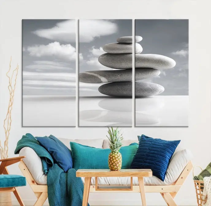 A gallery-quality Still Life Black and White Zen Stones Wall Art Canvas Print, featuring a triptych of stacked stones against a calm, cloudy background, adorns the room to bring an elegant touch.