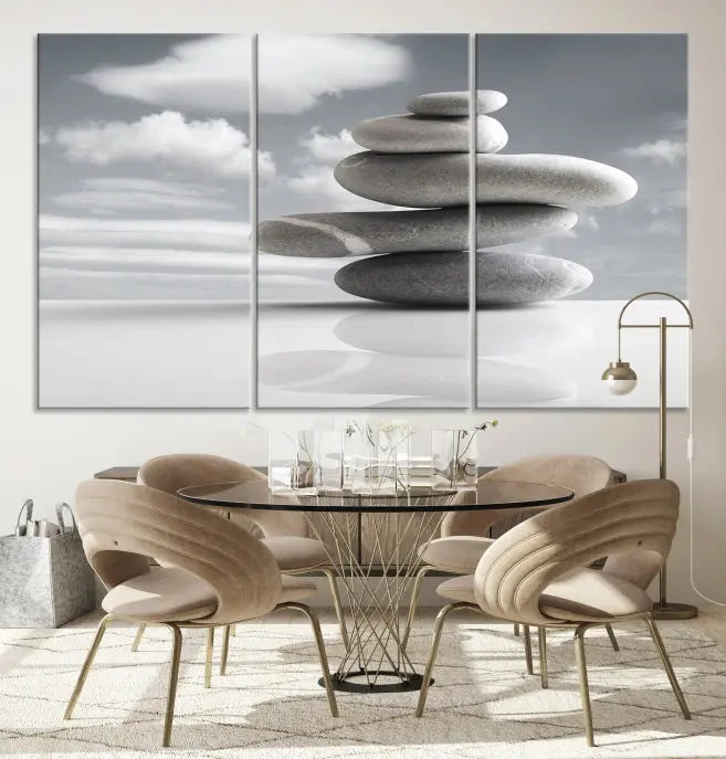 A gallery-quality Still Life Black and White Zen Stones Wall Art Canvas Print, featuring a triptych of stacked stones against a calm, cloudy background, adorns the room to bring an elegant touch.