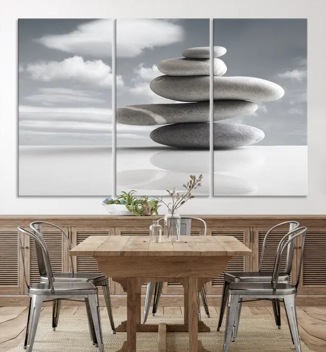 A gallery-quality Still Life Black and White Zen Stones Wall Art Canvas Print, featuring a triptych of stacked stones against a calm, cloudy background, adorns the room to bring an elegant touch.