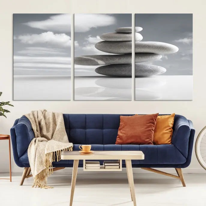 A gallery-quality Still Life Black and White Zen Stones Wall Art Canvas Print, featuring a triptych of stacked stones against a calm, cloudy background, adorns the room to bring an elegant touch.