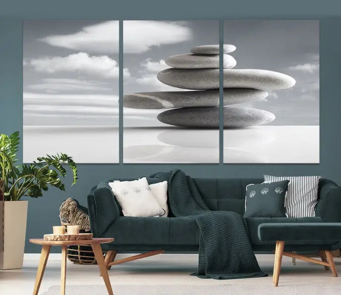 A gallery-quality Still Life Black and White Zen Stones Wall Art Canvas Print, featuring a triptych of stacked stones against a calm, cloudy background, adorns the room to bring an elegant touch.