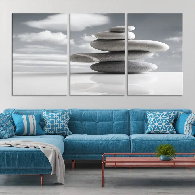 A gallery-quality Still Life Black and White Zen Stones Wall Art Canvas Print, featuring a triptych of stacked stones against a calm, cloudy background, adorns the room to bring an elegant touch.