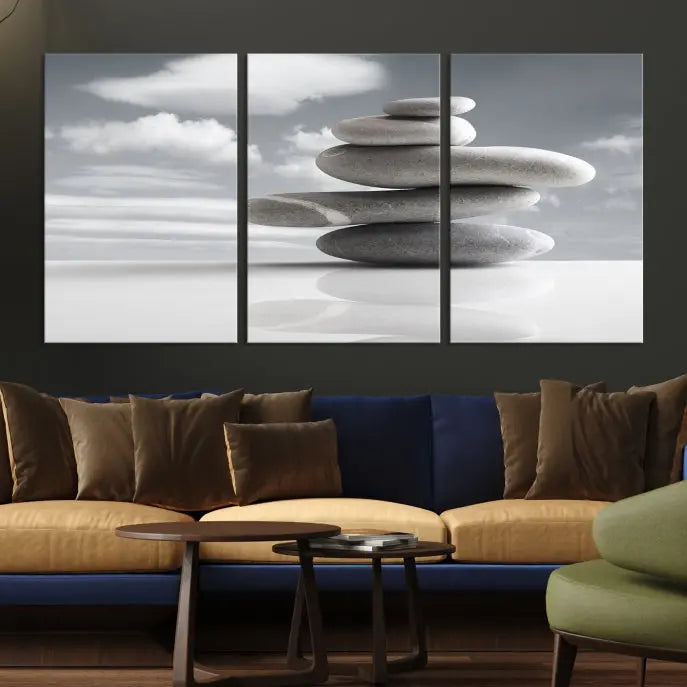 A gallery-quality Still Life Black and White Zen Stones Wall Art Canvas Print, featuring a triptych of stacked stones against a calm, cloudy background, adorns the room to bring an elegant touch.