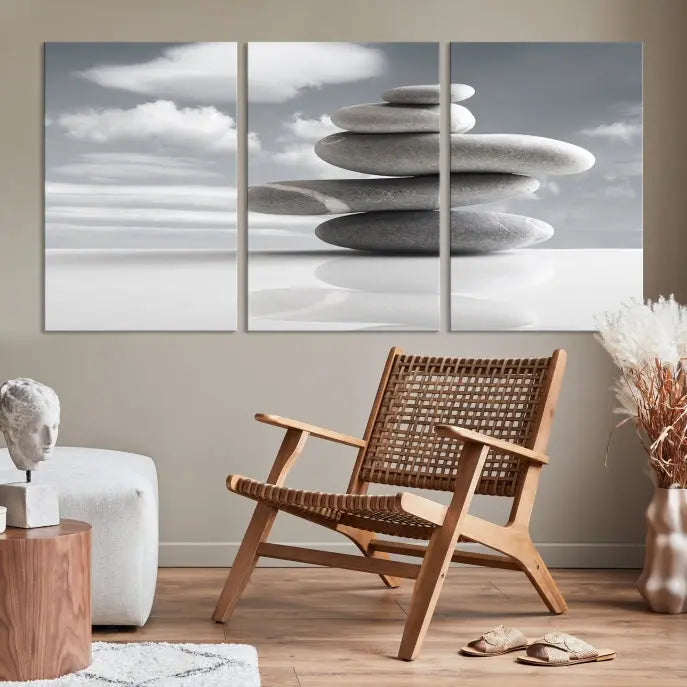 A gallery-quality Still Life Black and White Zen Stones Wall Art Canvas Print, featuring a triptych of stacked stones against a calm, cloudy background, adorns the room to bring an elegant touch.