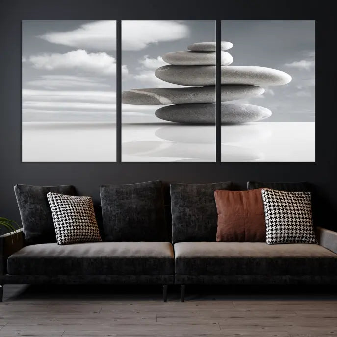 A gallery-quality Still Life Black and White Zen Stones Wall Art Canvas Print, featuring a triptych of stacked stones against a calm, cloudy background, adorns the room to bring an elegant touch.