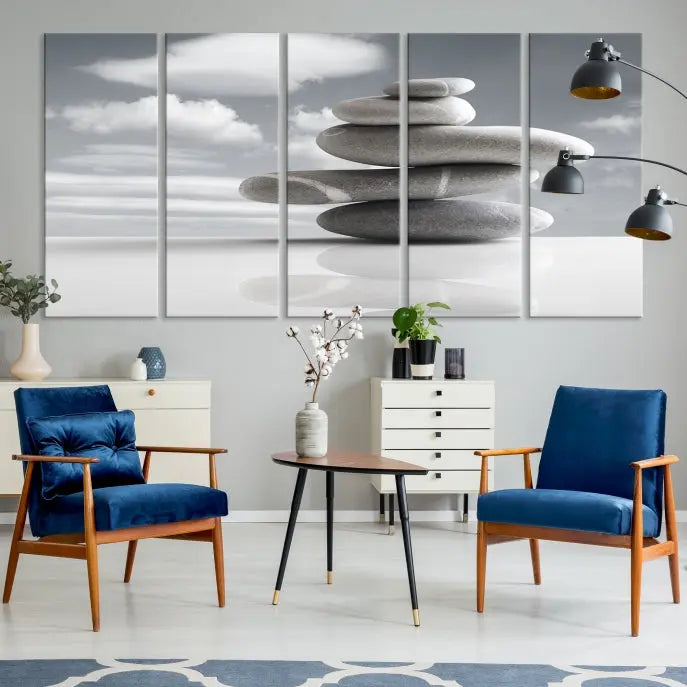 A gallery-quality Still Life Black and White Zen Stones Wall Art Canvas Print, featuring a triptych of stacked stones against a calm, cloudy background, adorns the room to bring an elegant touch.