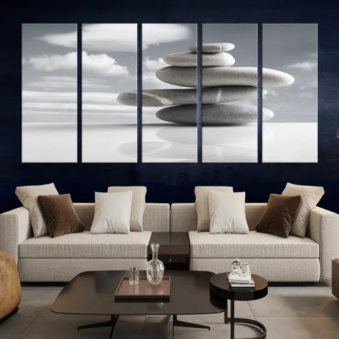 A gallery-quality Still Life Black and White Zen Stones Wall Art Canvas Print, featuring a triptych of stacked stones against a calm, cloudy background, adorns the room to bring an elegant touch.