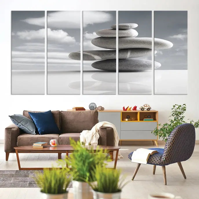 A gallery-quality Still Life Black and White Zen Stones Wall Art Canvas Print, featuring a triptych of stacked stones against a calm, cloudy background, adorns the room to bring an elegant touch.