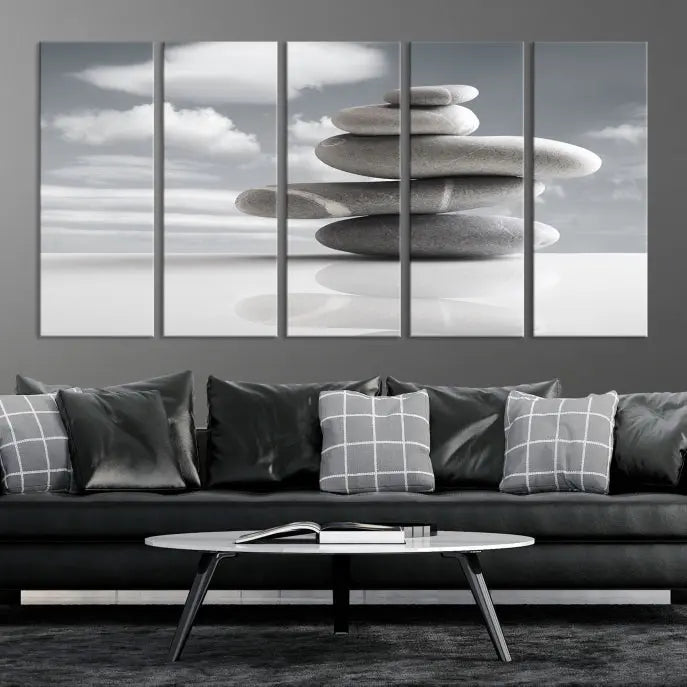 A gallery-quality Still Life Black and White Zen Stones Wall Art Canvas Print, featuring a triptych of stacked stones against a calm, cloudy background, adorns the room to bring an elegant touch.