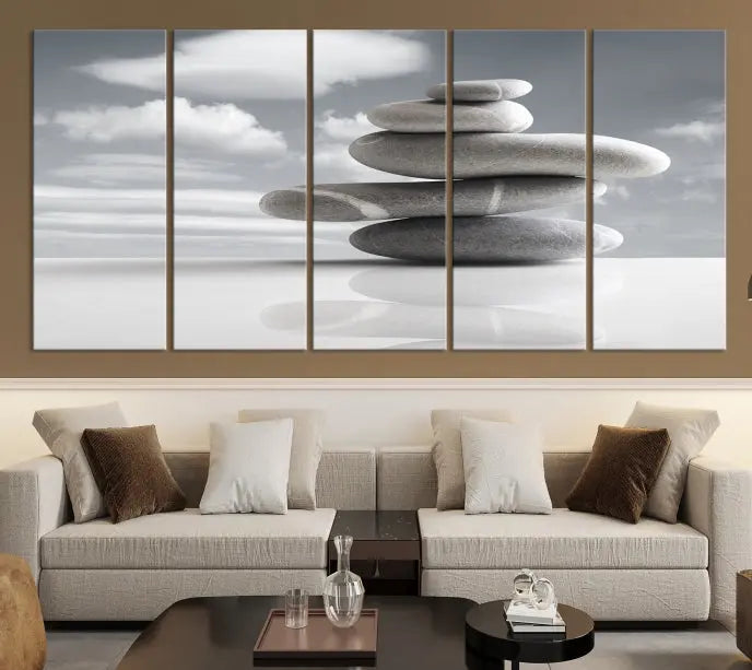 A gallery-quality Still Life Black and White Zen Stones Wall Art Canvas Print, featuring a triptych of stacked stones against a calm, cloudy background, adorns the room to bring an elegant touch.